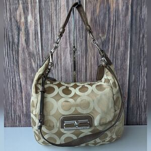 Coach Kristin Op Art Sateen Hobo bag. It features the brand's signature "Op Art"